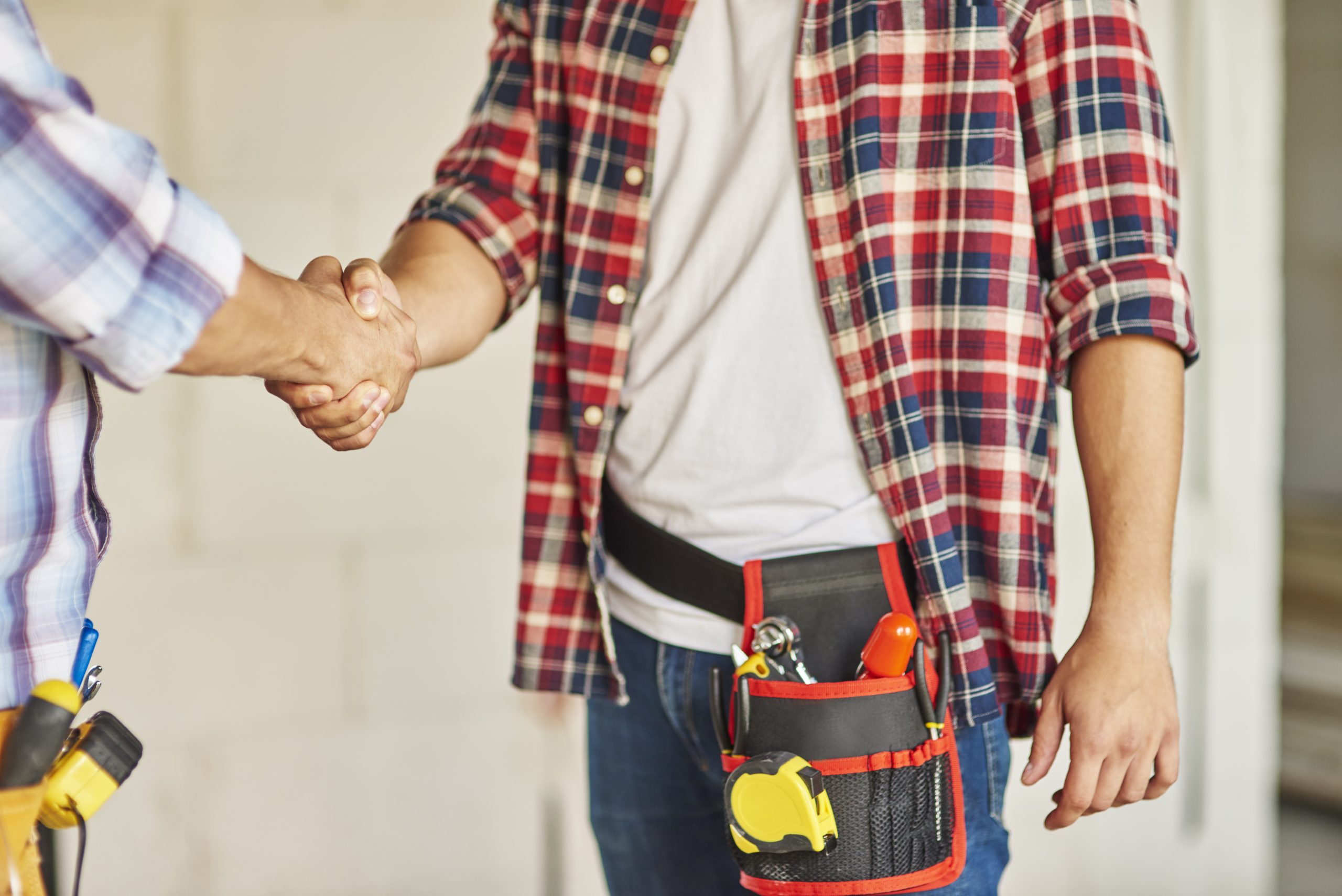 Close up of workers shaking hands